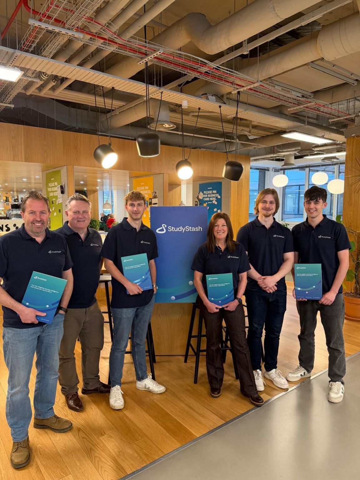 Six members of the StudyStash team with a company banner and brochures